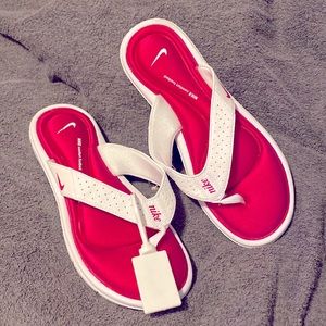Nike flip flops. New, never worn. Pink and white. Size 9 W.
